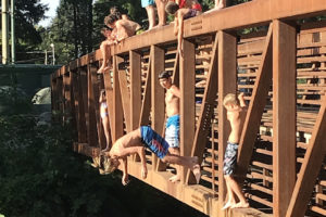Youth gather on the Lacamas Park Trail pedestrian bridge in August 2019, days before a 14-year-old Vancouver boy drowned in the stretch of water below. (Post-Record file photo)