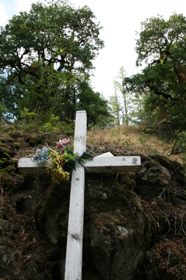 A cross near the Lacamas Park ?potholes? symbolizes one of several fatalities that have occurred in the area.