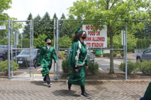 Hayes Freedom High School seniors from the class of 2021, including Jazmyn Dunn, 17 (right), walk toward their high school graduation ceremony on Saturday, June 12, 2021, at Doc Harris Stadium in Camas. (Kelly Moyer/Post-Record)