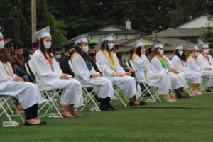 Washougal High School seniors wear face coverings to prevent the spread of COVID-19 and listen to a speech at their high school graduation ceremony on Saturday, June 12, 2021. (Doug Flanagan/Post-Record)