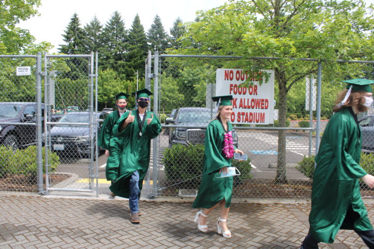 Members of the Hayes Freedom High School class of 2021 walk toward their graduation ceremony at Doc Harris Stadium on Saturday, June 12, 2021. (Kelly Moyer/Post-Record) 