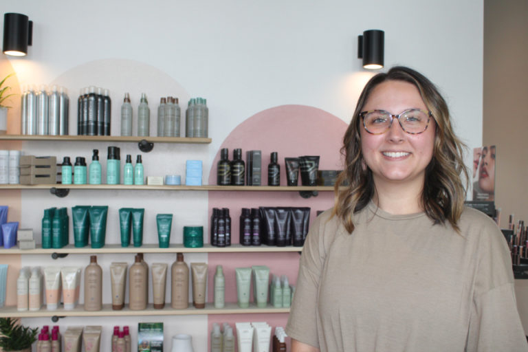 Moonlight Salon owner Megan Strand stands near a display of Aveda hair products inside her downtown Camas salon on June 11, 2021.