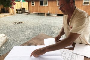 Washougal resident Joe Webster points to a section of the blueprint design he created for the seasonal outdoor barbecue restauarant he hopes to open on his "E" Street property. (Doug Flanagan/Post-Record)