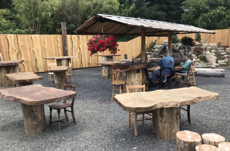 Joe Webster created an outdoor seating area, including handcrafted wood tables, chairs and a bar, at his property on &quot;E&quot; Street in Washougal for the seasonal outdoor barbecue restaurant he would like to open.