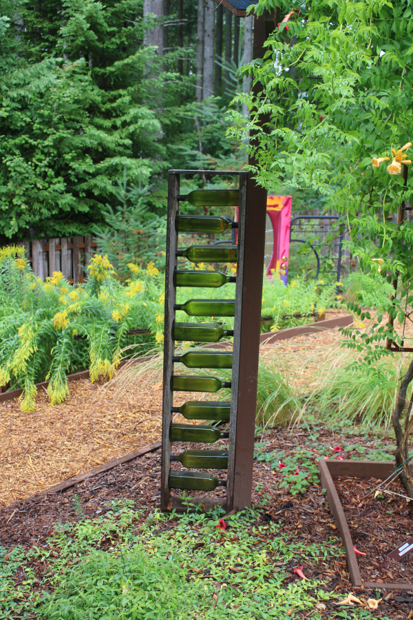 Ken Crouch enjoys upcycling used materials, such as these used olive oil bottles, to create artwork for the 1.7-acre garden he and his wife, Marge Crouch, have built at their Camas home.