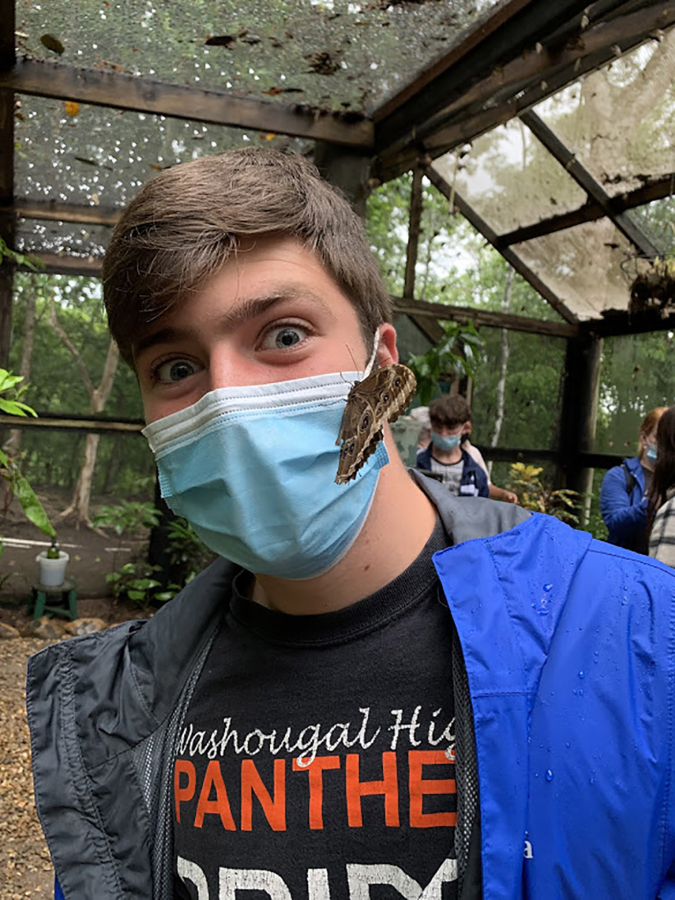 Washougal High School student Blake Scott is visited by a butterfly during an educational trip to Belize in July.