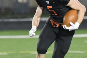 Washougal High School football player Gavin Multer runs the ball during a March 2021 game. (Contributed photos courtesy of Kris Cavin)