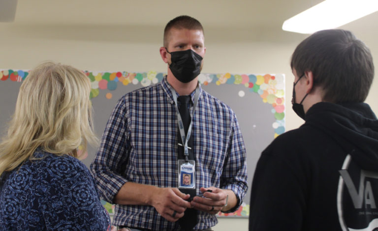 Camas Connect Academy Principal Daniel Huld (center) speaks to a family during "back-to-school night" on Tuesday, Aug. 24, 2021.