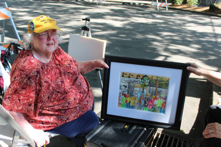 Kelly Moyer/Post-Record files 
 Artist Ann Amies shows her finished artwork during the 2018 Plein Air event in downtown Camas.