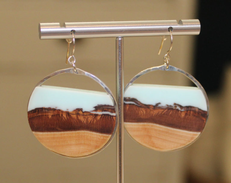 Earrings made of wood, resin and silver crafted by Branch and Barrel, a Bend, Ore.-based art studio that plants a tree for every pair of earrings sold, hang inside Poppy & Hawk, a new retail shop in downtown Camas, on Thursday, Aug. 26, 2021.