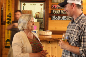 54-40 Brewing Co. owner Bolt Minister (right) talks to then-Washougal Mayor Pro Tem Joyce Lindsay (left) during a fundraiser at the Washougal brewpub on May 9, 2018. Minister and his wife, Amy Minister (not pictured) recently opened a second 54-40 location in Skamania County. (Post-Record file photos)