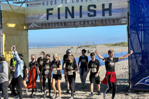 Members of the Washougal High School "Shougalicious" running team celebrate after winning the 2021 Portland to Coast Challenge Relay Run in Seaside, Ore., on Aug. 29, 2021. (Contributed photo courtesy of Tracey Stinchfield)