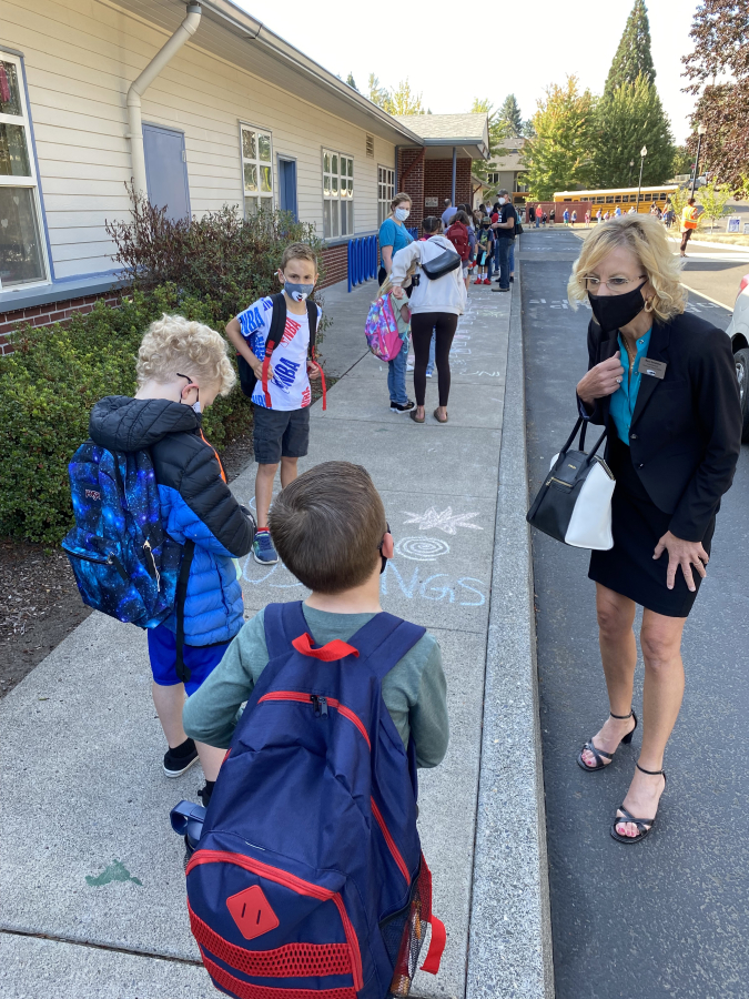Washougal School District Superintendent Mary Templeton (right) greets students outside Gause Elementary School on Aug. 31, 2021, the first day of the 2021-22 school year.