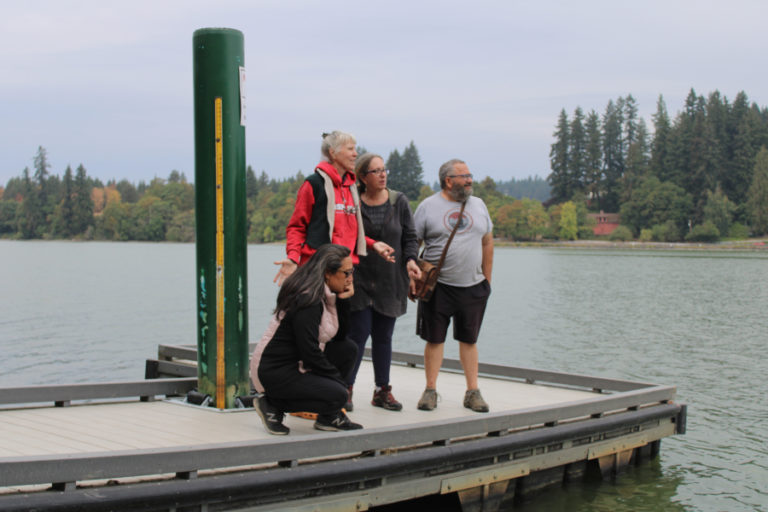Camas residents (from left to right) Marie Tabato, Susan Knilans, Deborah Nagano and Randal Friedman stand on a boat dock created by the Lacamas Shores homeowners association on Lacamas Lake in Camas on Friday, Sept.