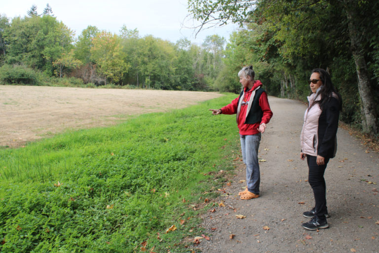 Camas residents Susan Knilans (left) and Marie Tabata Callerame (right) point out an example of a healthy strip of grasses and plants acting as a biofilter along the city of Camas&#039; Heritage Trail, in between the Lacamas Shores housing development and Lacamas Lake on Friday, Sept.