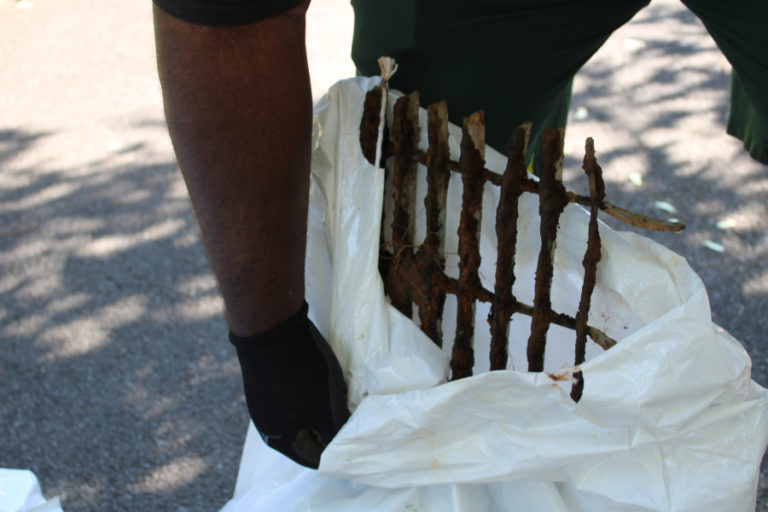 Lamont Warren, of Portland, shows one of two grills his family discovered on the shores of Lacamas Lake during the annual lake cleanup event on Saturday, Sept.