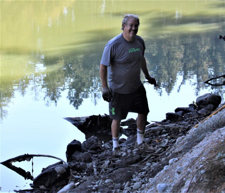 Tom Tangen, of Vancouver, combs the shores of Lacamas Lake during the annual lake cleanup on Saturday, Sept.