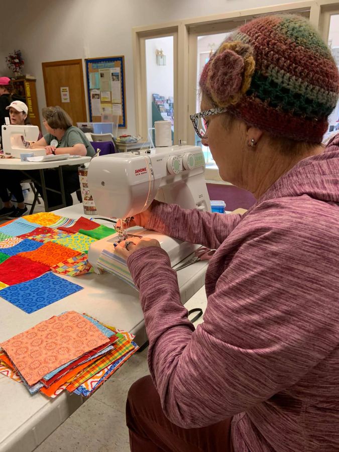 Contributed photo courtesy Peri Muhich 
 Diane Schmitt works on a &quot;charity quilt&quot; during a meeting of the Cape Horn Quilters in Washougal.