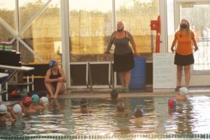 Washougal girls swimming coach Denise Croucher (right) and Hockinson girls swimming coach Michelle Jacobs-Brown (center) demonstrate proper technique during a practice session at Lacamas Athletic Club on Thursday, Sept. 23, 2021. (Doug Flanagan/Post-Record)