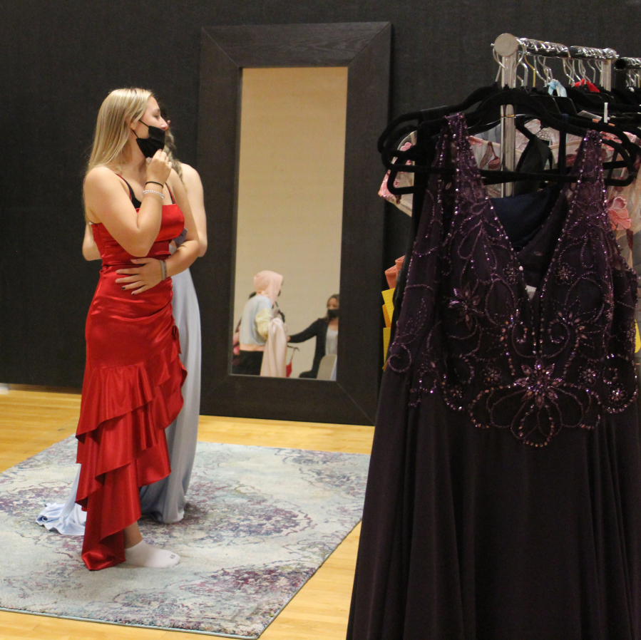 Washougal High School senior Taylor Poulsen tries on a dress during the "Giving Gown Gala" event at Washougal High School on Oct. 8, 2021. (Photos by Doug Flanagan/Post-Record)
