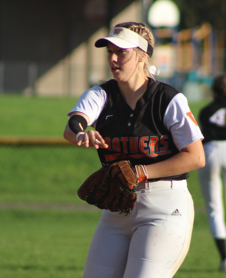 Washougal&#039;s Natalie Collins throws a ball to first base during the first game of a doubleheader against Columbia River High School on Oct. 11, 2021.