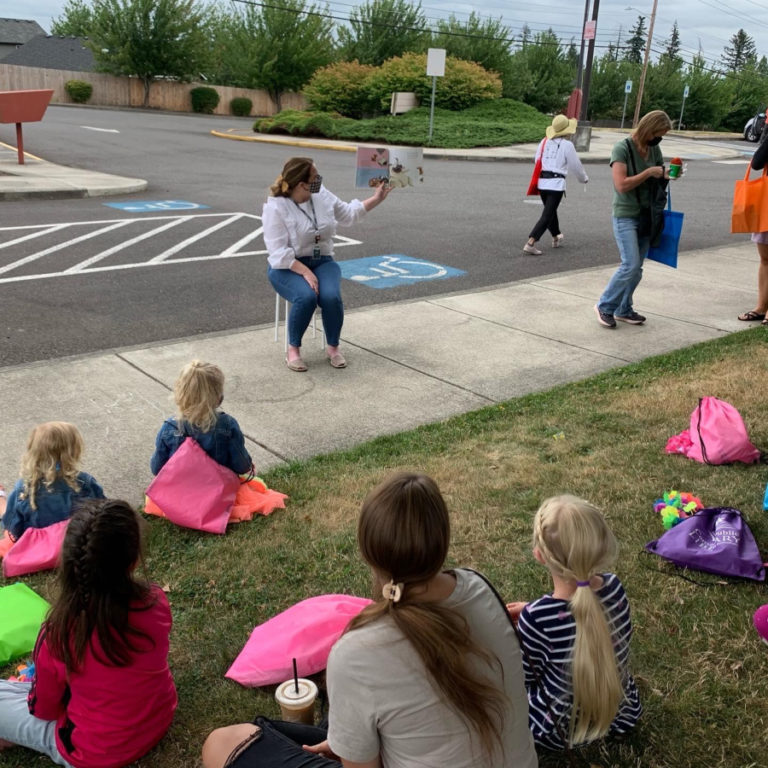 Camas School Board member Erika Cox reads to students and families during a 2021 summer reading program.
