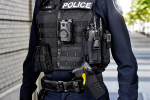 An officer models the type of AXON body-worn camera and taser Camas police officers will begin wearing in April 2022. (Photo courtesy of AXON)