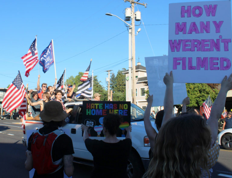 Black Lives Matter supporters call for social and racial justice in downtown Camas as a truck filled with youth flying Donald Trump, American and "thin blue line" flags and shouting support for a "Back the Blue" rally passes by on Aug. 28, 2020.