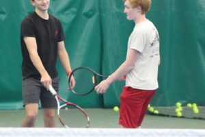 Washougal High School tennis players Tucker Kneipp (left) and Gavin Kestner tap rackets after winning a point during a practice match at Evergreen Tennis Club in Camas on Oct. 22, 2021. (Doug Flanagan/Post-Record)