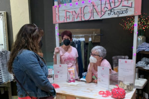 Pink Lemonade Project representatives greet visitors to their booth during the 2021 Camas Girls Night Out event on Sept. 23, 2021. Pink Lemonade Project's Pink Practicalities program received a $4,000 grant from the Camas-Washougal Community Chest in 2021 to help Camas-Washougal residents undergoing breast cancer treatment pay for expenses not covered by health insurance. (Contributed photo courtesy of Pink Lemonade Project)