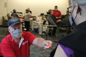 Keith Mills (left) helps a community member sign up to donate blood during an American Red Cross blood donation event at Cascade Park Library in Vancouver, on Oct. 28, 2021. (Kelly Moyer/Post-Record)