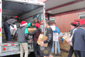 Camas High students don Santa Claus hats to load donations during the annual Stuff the Bus event on Dec. 4, 2015. (Post-Record files)