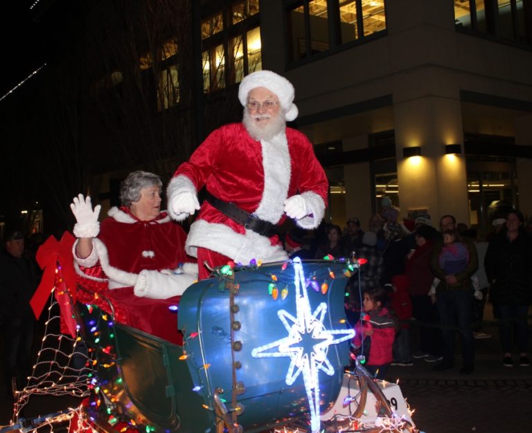 Santa and Mrs. Claus wave from an illuminated float during the 2019 Washougal Lighted Christmas Parade.
