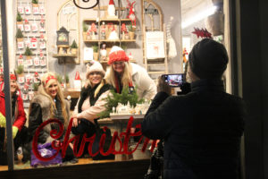 A group gathers for a photo inside Camas Antique's front window during the 2018 Camas Hometown Holidays celebration on Dec. 7, 2018. (Kelly Moyer/Post-Record files)