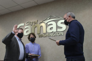 Newly elected Camas Mayor Steve Hogan (left) takes his oath of office inside Camas City Hall on Tuesday, Nov. 23, 2021. Also pictured are Hogan's wife, Mary Beth Hogan (center), and Camas City Attorney Shawn MacPherson (right). (Kelly Moyer/Post-Record)