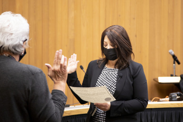 Newly elected Washougal Mayor Rochelle Ramos (right) takes her oath of office inside Washougal City Hall, in a ceremony livestreamed on the city&#039;s website, on Tuesday, Nov. 23, 2021.