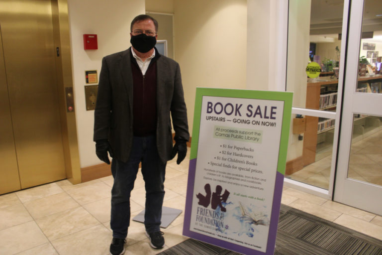 Camas Mayor Steve Hogan visits the Camas library&#039;s annual book sale during the city of Camas&#039; 2021 Hometown Holidays event on Friday, Dec.