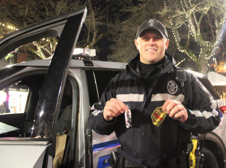 Camas police officer Jason Langman greeted young visitors with stickers and other goodies during the city of Camas’ 2021 Hometown Holidays event on Friday, Dec. 3, 2021. (Kelly Moyer/Post-Record)