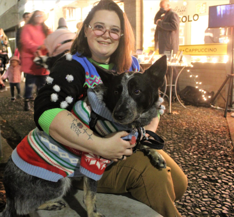 Amanda Bonney, of La Center, and her 4-year-old dog, Bruno, show off their Christmas sweaters at the Camas Hometown Holidays event on Friday, Dec. 3, 2021. (Kelly Moyer/Post-Record)