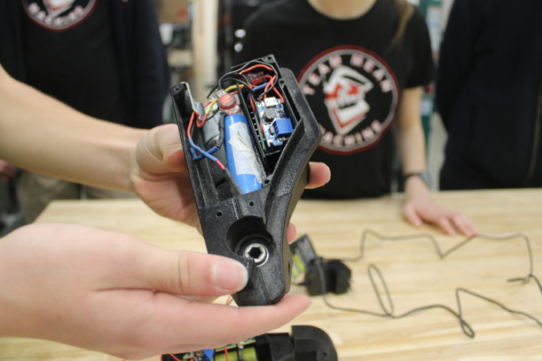 A Discovery High School student shows the inner workings of the remote-controlled "Power Pivot" device created by Camas-Washougal students to help people with limited mobility rotate without having to twist their bodies, inside the Discovery High STEM lab on Wednesday, Dec. 1, 2021.