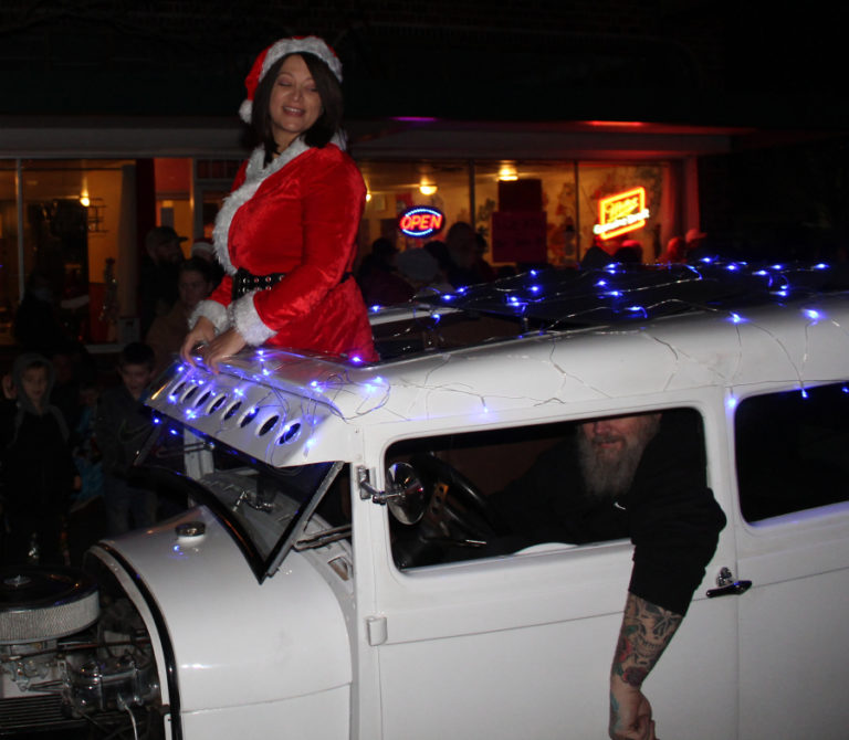 Washougal Mayor Rochelle Ramos is driven by her partner, John Henriksen, in their vintage Ford Model A during the Washougal Lighted Christmas Parade on Thursday, Dec 2, 2021. (Doug Flanagan/Post-Record)