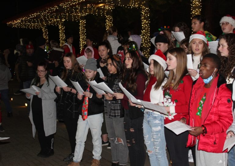 The Washougal High School choir sings in Reflection Plaza during the Washougal Lighted Christmas Parade and Tree Lighting event on Thursday, Dec 2, 2021. (Doug Flanagan/Post-Record)