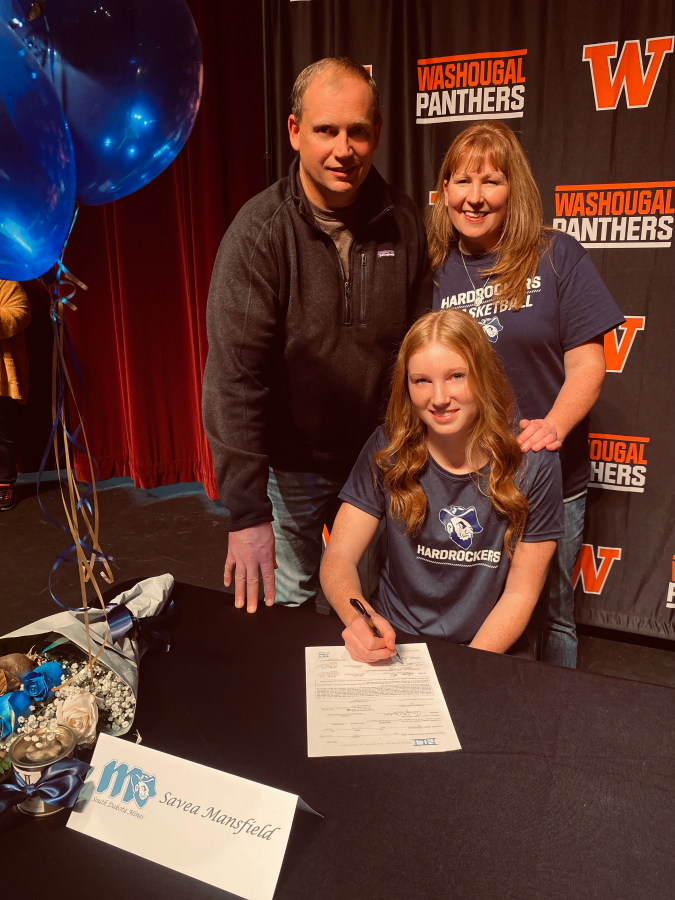 Washougal High School senior Savea Mansfield signs a letter of intent to continue her basketball career at the South Dakota School of Mines and Technology in Rapid City, South Dakota, in late November, flanked by her parents Jason and Deborah.