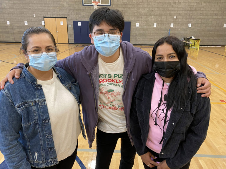 Washougal residents Sarahi Castro (left) and Damaris Castro (right) provide support for students, including Sarahi&#039;s son, Daniel Lara (center), during a La Chispa session at Jemtegaard Middle School in May 2021.