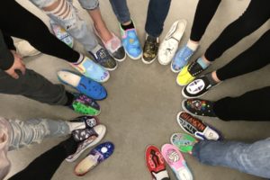 Washougal students show shoes they created for the "Roots and Wings" art project, which asked students to depict where they came from and where they hope to be, in December 2021. (Contriuted photo courtesy of the Washougal School District)