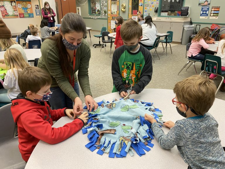 From left to right: Canyon Kuthe, Heather Nolin, Henry Dye and Ryker Nolin make a blanket for West Columbia Gorge Humane Society shelter animals at Cape Horn-Skye Elementary School in Washougal in December 2021.