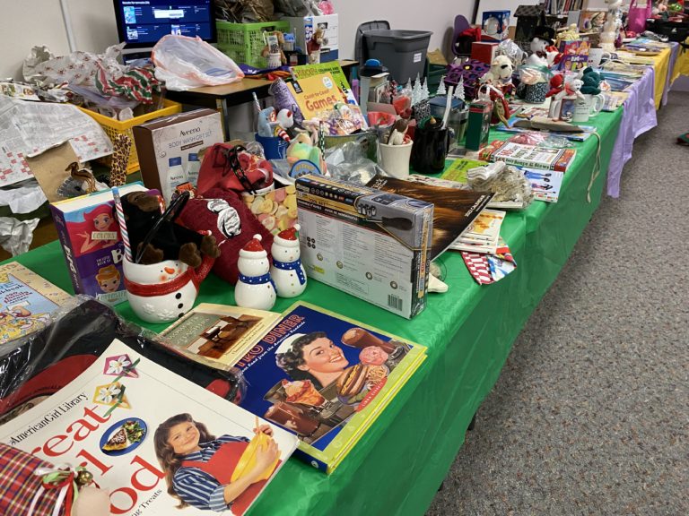 Tables of donated items await student shoppers at Hathaway Elementary School's annual holiday shop in December 2021.