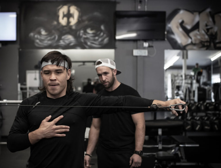 Professional mixed martial arts fighter Ricky Simon works out while Jess Guthmiller, his strength and conditioning coach, looks  on during a traning session at Champ Camp Training and Fitness in Washougal in 2021.