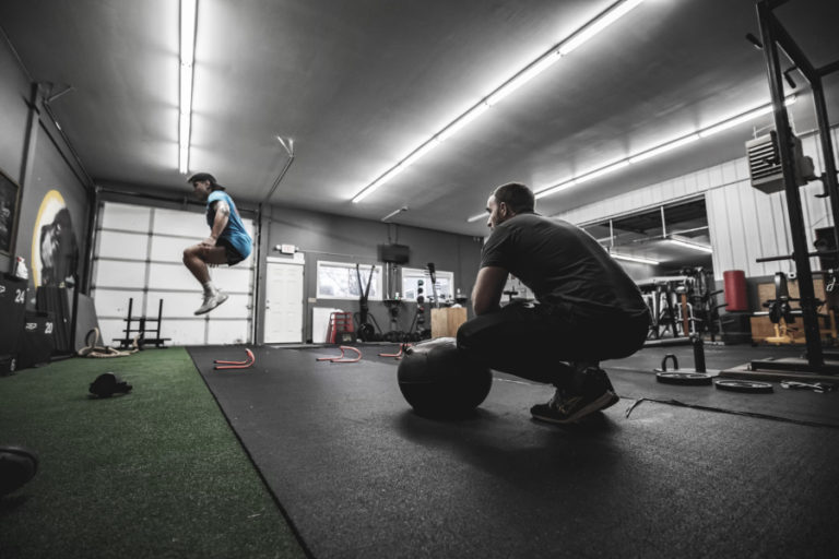 Simon works out while Guthmille looks on during a traning session at Champ Camp Training and Fitness in Washougal in 2021.