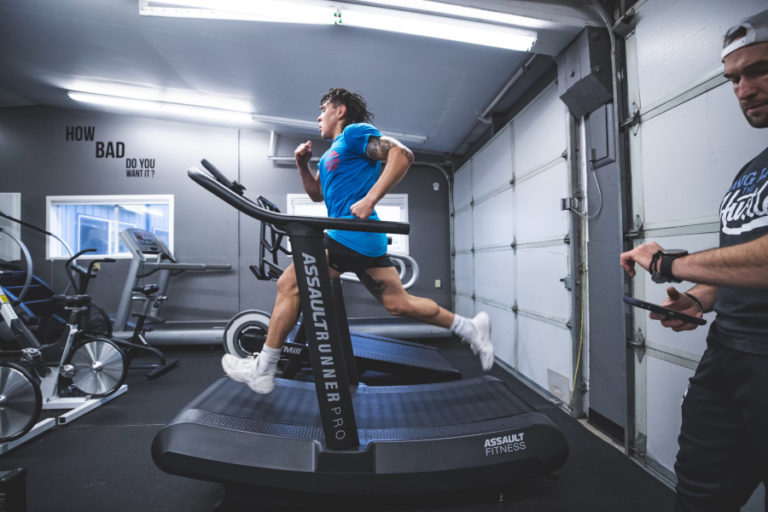 Ricky Simon  runs during a training session with his coach, Jess Guthmiller, at Champ Camp Training and Fitness in 2021.